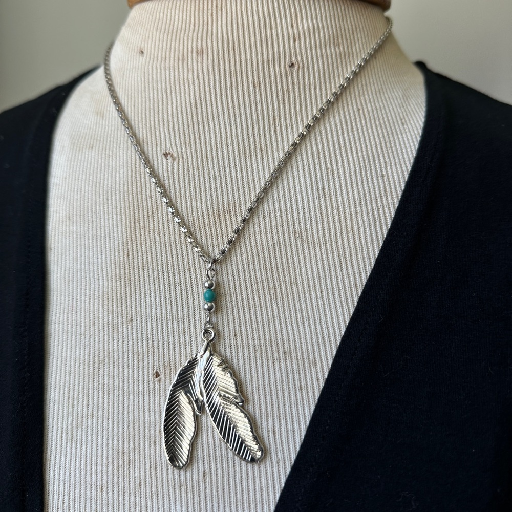 Silver tone feather necklace